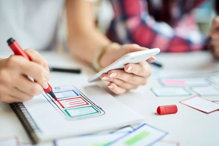 Closeup of designers creating mobile app prototype